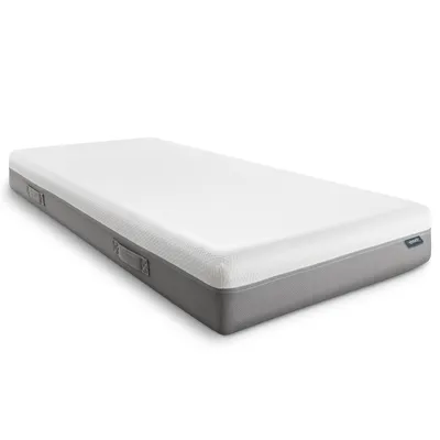 A white and gray mattress is shown from a diagonal angle against a white background.