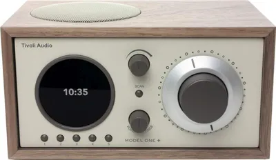 A Tivoli Audio Model One+ radio in a walnut and beige finish, shown from the front.