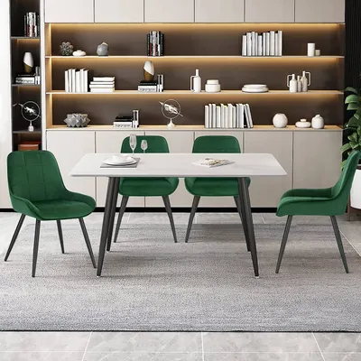 A dining table and four chairs are set up in a modern dining room with shelves in the background.