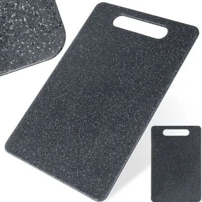 A dark gray speckled cutting board with a handle cutout, shown from a slightly elevated angle.