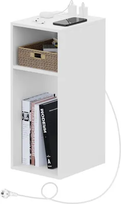A white, two-shelf nightstand with a basket and books on the shelves, and charging cables and a phone on top.