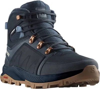 A studio shot of a single blue Salomon winter boot.