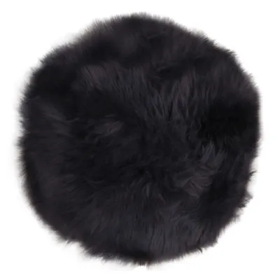 A round, black, fluffy sheepskin seat pad.