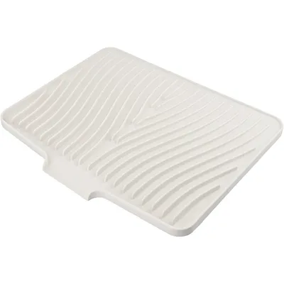 A white silicone dish drying mat with a wavy pattern.