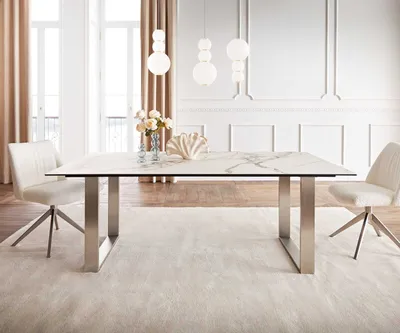 A dining table with chairs in a well-lit room.