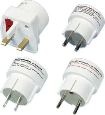 Four white travel adapters are arranged on a white background.