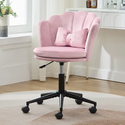 A pink office chair with a scalloped back and a butterfly-shaped lumbar pillow is shown in a room with a window and a vanity.