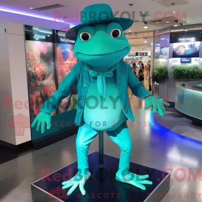 Obrázek produktu pro Postava REDBROKOLY maskota tyrkysové žáby oblečená do body a čepice