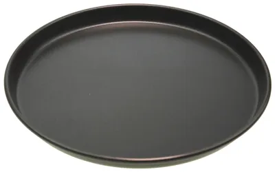 A black, round baking dish with a slightly raised rim, shown from a diagonal angle against a white background.
