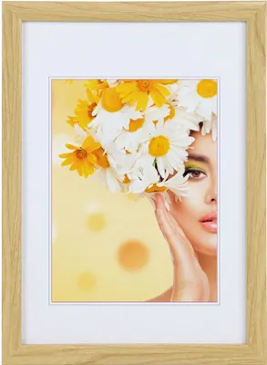 A framed portrait of a woman with flowers in her hair.