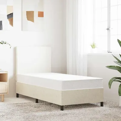A bedroom scene with a single bed and mattress.