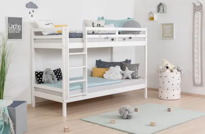 A white wooden bunk bed in a child's bedroom, decorated with pillows and stuffed animals.