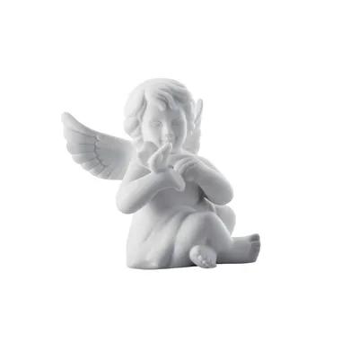 A white porcelain angel figurine holding a small bird.