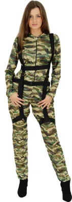 A woman is standing and posing in a camouflage jumpsuit.