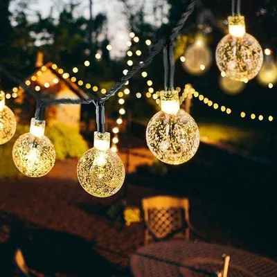 Immagine prodotto di Ghirlanda luminosa impermeabile da 50 LED per il giardino con sensore di luce