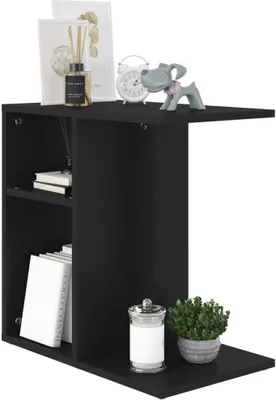 A black side table with shelves, decorated with various items.