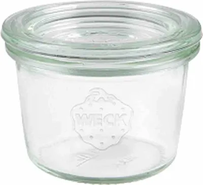 A clear glass jar with the brand name embossed on it.