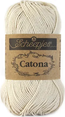 A ball of cream-colored yarn with a brown paper label.