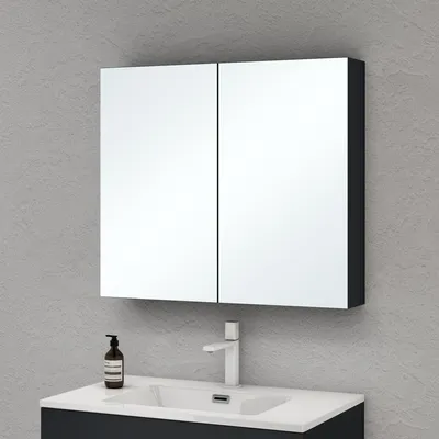 A mirrored medicine cabinet above a bathroom sink and faucet.