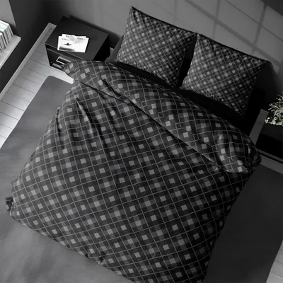 A top-down view of a bed with anthracite-colored flannel bedding featuring a plaid pattern.