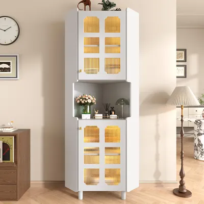 A white corner cabinet with glass doors and gold accents, decorated with flowers and other items, is shown in a room with a clock and a floor lamp.