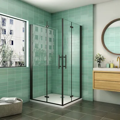 A modern bathroom with a glass shower enclosure, a vanity with a sink and mirror, and a window overlooking a building.