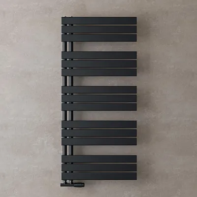 A black radiator against a textured gray wall.