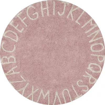 A round rug with letters of the alphabet around the edge.