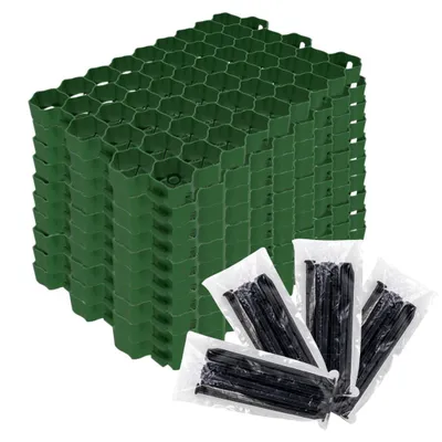 A stack of green hexagonal grid panels and several small plastic bags containing black stakes, likely for landscaping or ground stabilization.