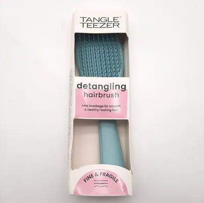 A Tangle Teezer detangling hairbrush in its packaging, displayed against a white background.