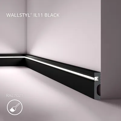 A black LED light strip installed along the base of a wall in a corner, with white light emanating from it.