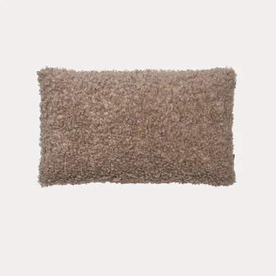 A rectangular, textured pillow is centered on a light gray background.