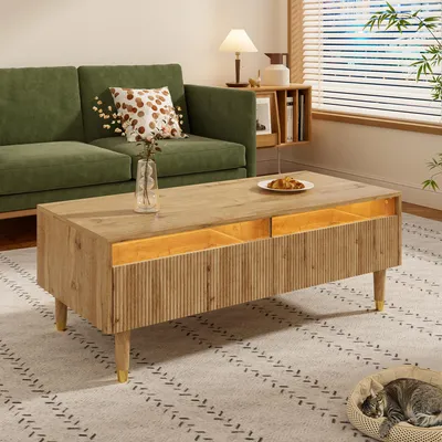 A living room scene with a green sofa and a wooden coffee table.