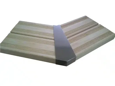 A corner joint for wooden pool decking, made of wood and metal.