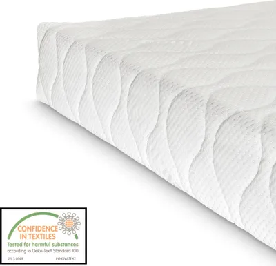 A close-up, angled view of a white mattress with a quilted pattern.