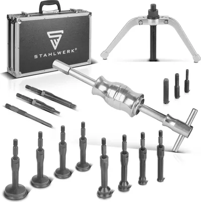 A set of automotive tools, including a slide hammer, adapters, and a carrying case, laid out on a white background.