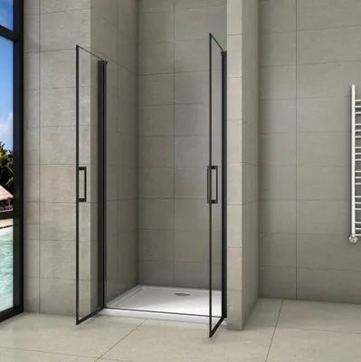 A modern bathroom with a glass shower enclosure.