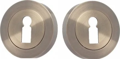Two identical bronze-colored keyhole escutcheons are shown against a white background.