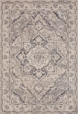 A top-down view of a rug with a distressed, traditional pattern.