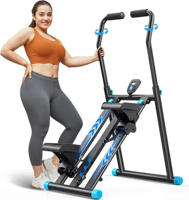 A woman is posing next to a stepper machine.