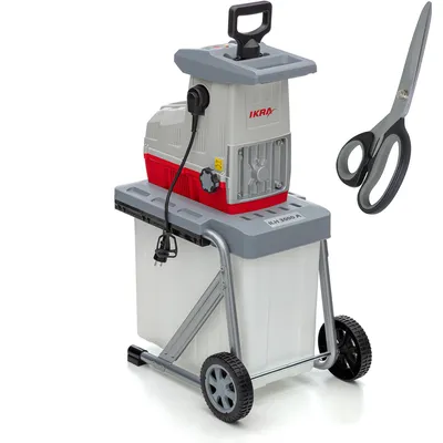 A garden shredder with a collection bin and a pair of scissors next to it, on a white background.