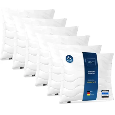 A stack of white pillows arranged diagonally.