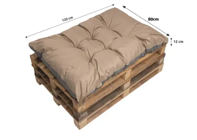 A beige cushion placed on a wooden pallet.