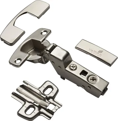 A set of cabinet hinges and mounting plates are laid out on a white background.
