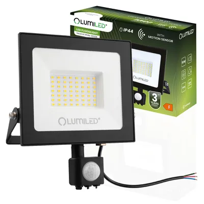 A Lumiled LED floodlight with a motion sensor is shown in front of its packaging.