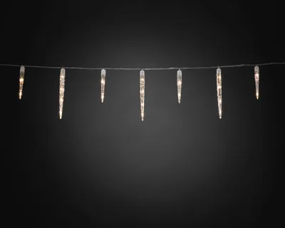 A string of icicle-shaped LED lights hangs against a dark background.