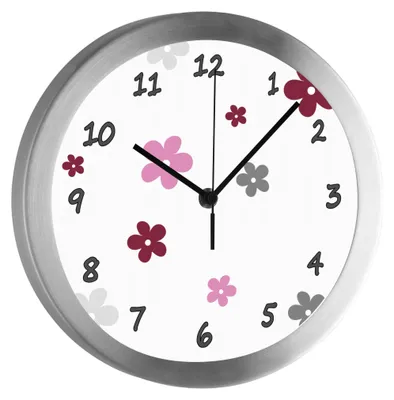 A close-up of a wall clock with a floral design.