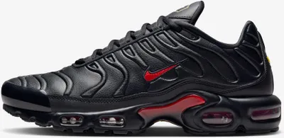 A side view of a black Nike Air Max Plus sneaker with red accents.