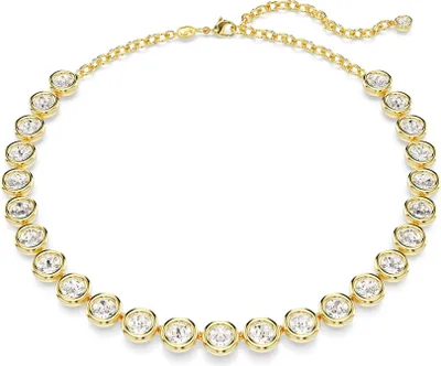 A gold necklace with clear stones on a white background.