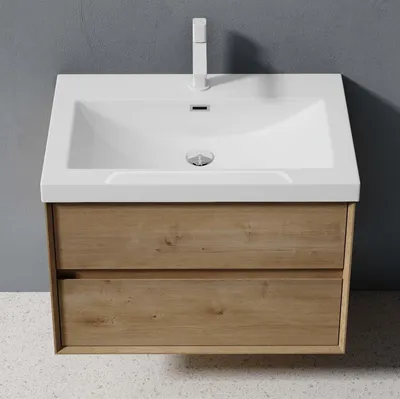 A wall-mounted bathroom vanity with a white sink and a wooden cabinet with two drawers, set against a gray wall.